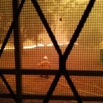 Looking through hall kitchen window at fire